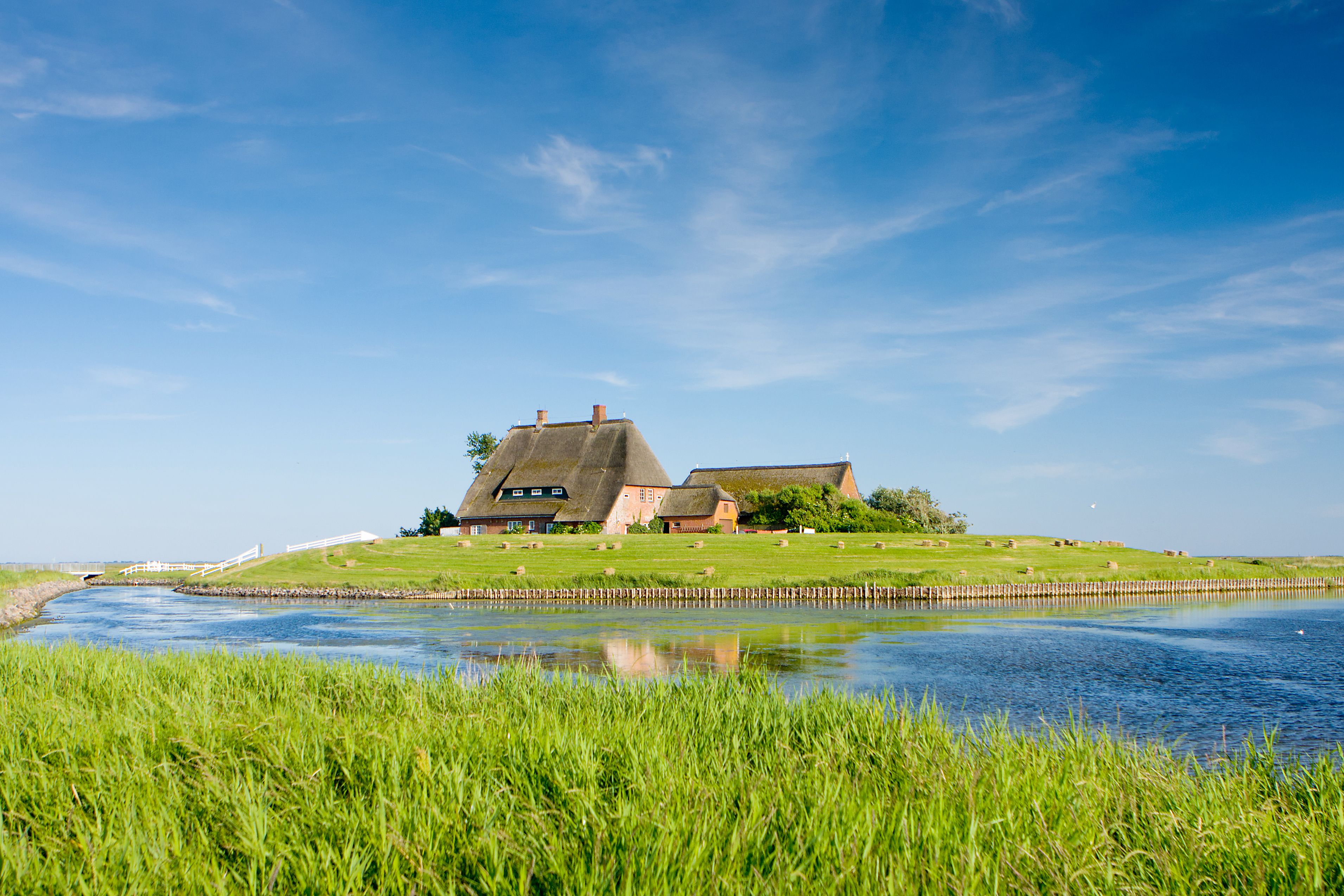 Kirchwarft auf Hallig Hooge von Wasser umspült