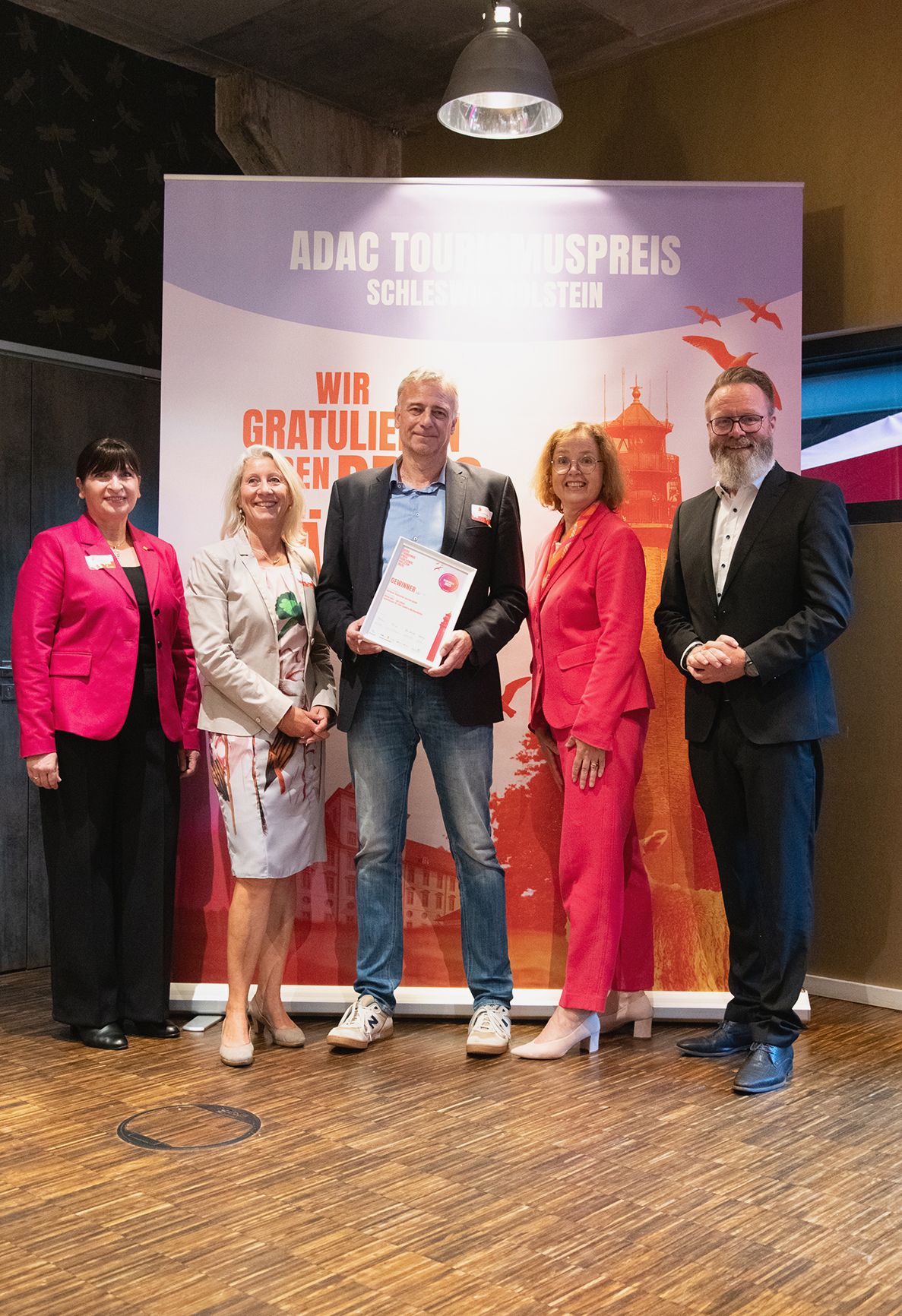 Die Verleihung des ADAC Tourismuspreises Schleswig-Holstein durch den ADAC SH in Neumünster. Auf der Bühne stehen  (von links nach rechts) -	Katrin Telschow - Vorstandsmitglied für Touristik ADAC Schleswig-Holstein e. V., -	Iris Petersen als Niederlassungsleiterin bei Ströer DSM GmbH (Hauptsponsor), Gewinner Frank Ketter, Geschäftsführer der Nordsee-Tourismus-Service GmbH, Betina Bunge, Geschäftsführerin Tourismus Agentur SH sowie der Wirtschafts- und Tourismusminister des Landes SH Claus Ruhe Madsen.