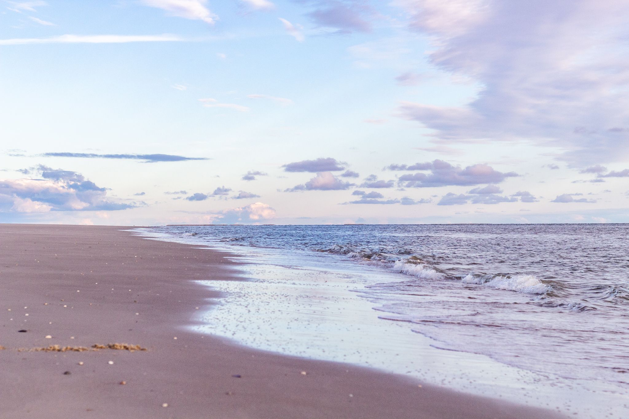 Strand von Amrum im Sonnenuntergang erscheint in rotem Licht. 